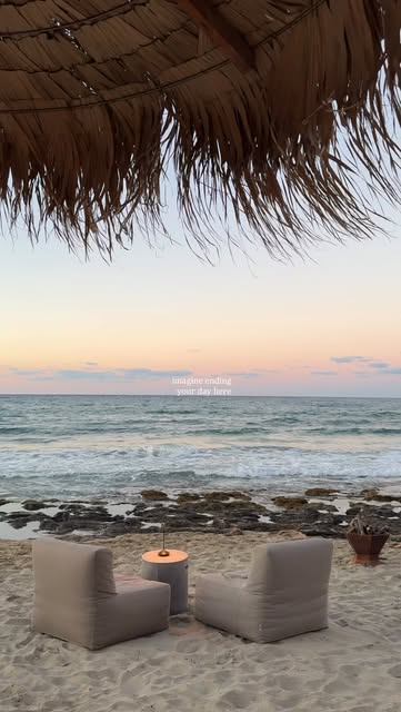 Quiet beachside lounge beneath a thatched parasol at sunset